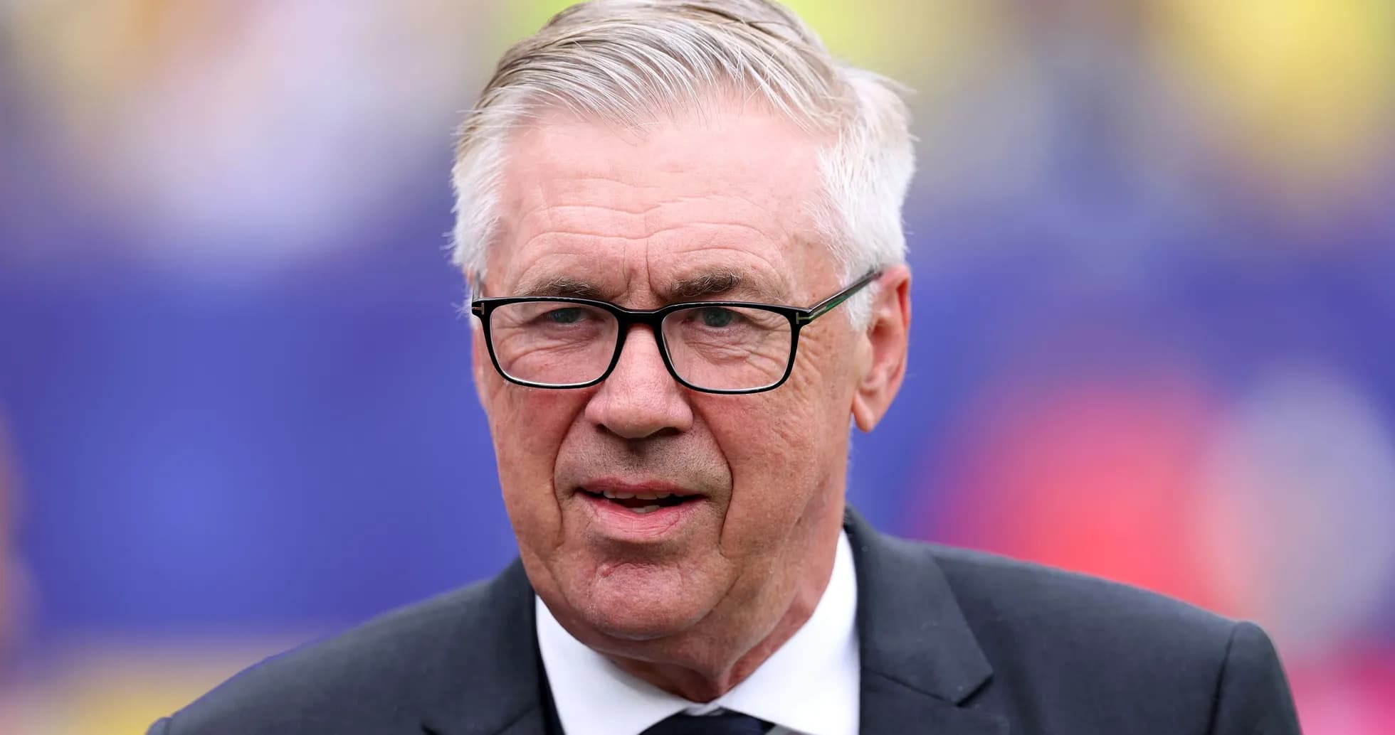 Coach in suit and glasses at event Coach in suit and glasses at event