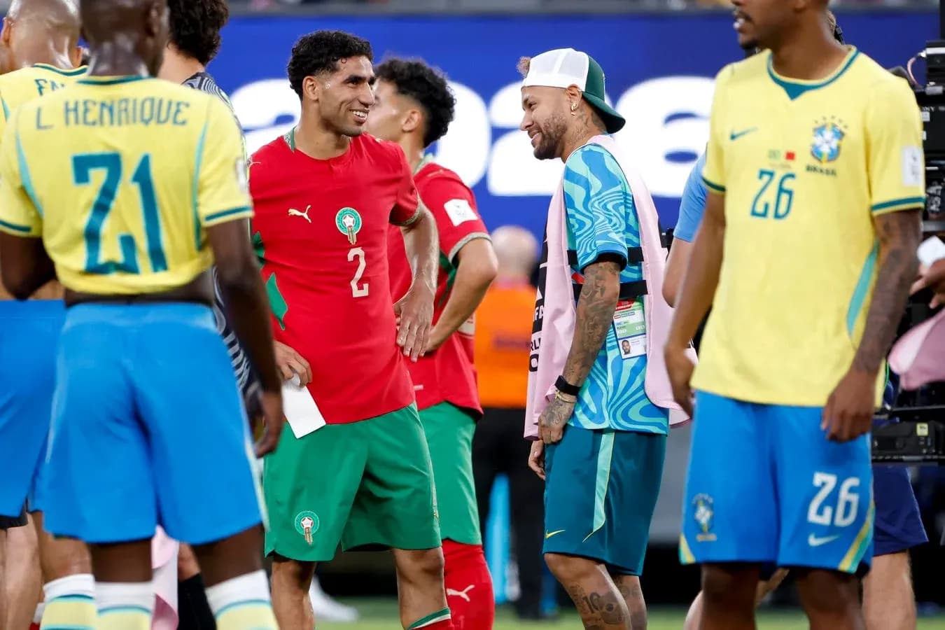 Players from Morocco and Brazil interacting on field Players from Morocco and Brazil interacting on field