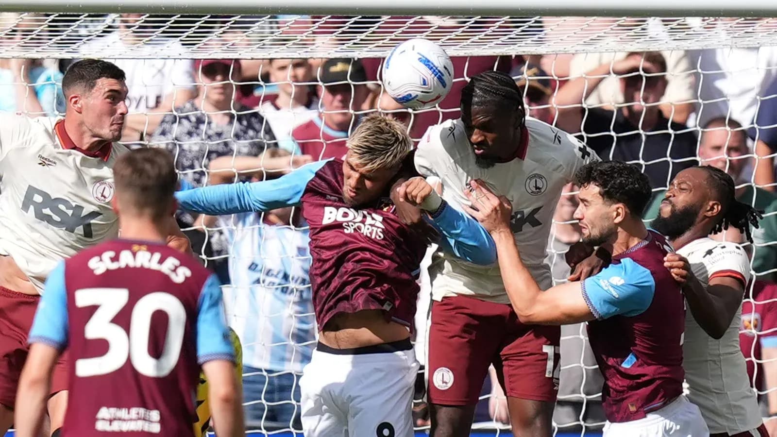 Players contesting a header in front of goal Players contesting a header in front of goal