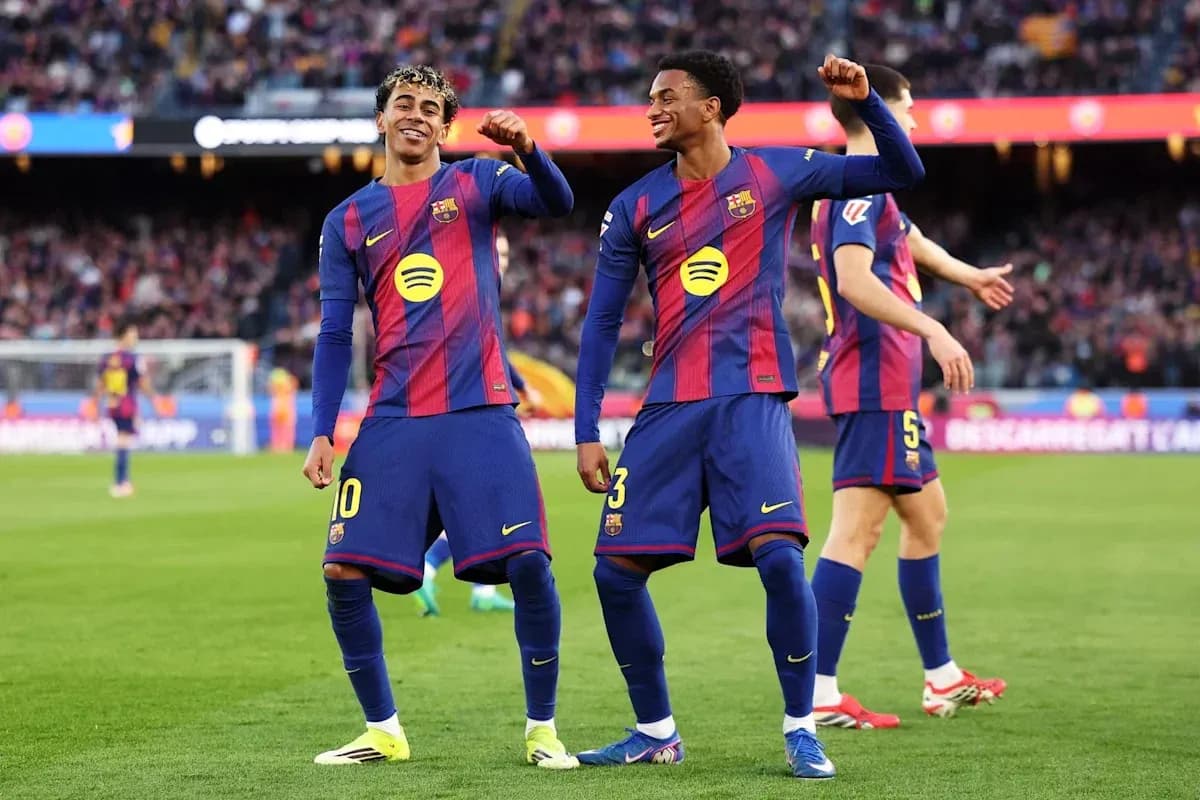 Two FC Barcelona players celebrating a goal Two FC Barcelona players celebrating a goal