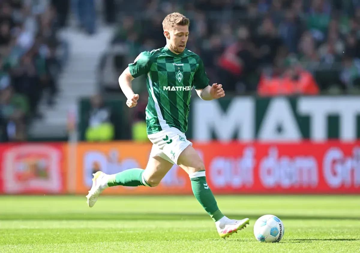 Player in green kit running with soccer ball Player in green kit running with soccer ball
