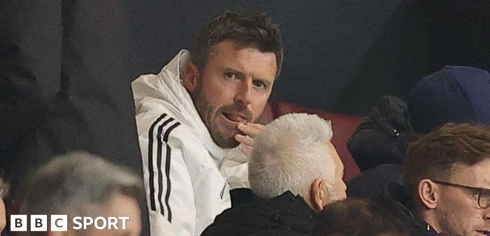 Man in white jacket watching from the stands Man in white jacket watching from the stands