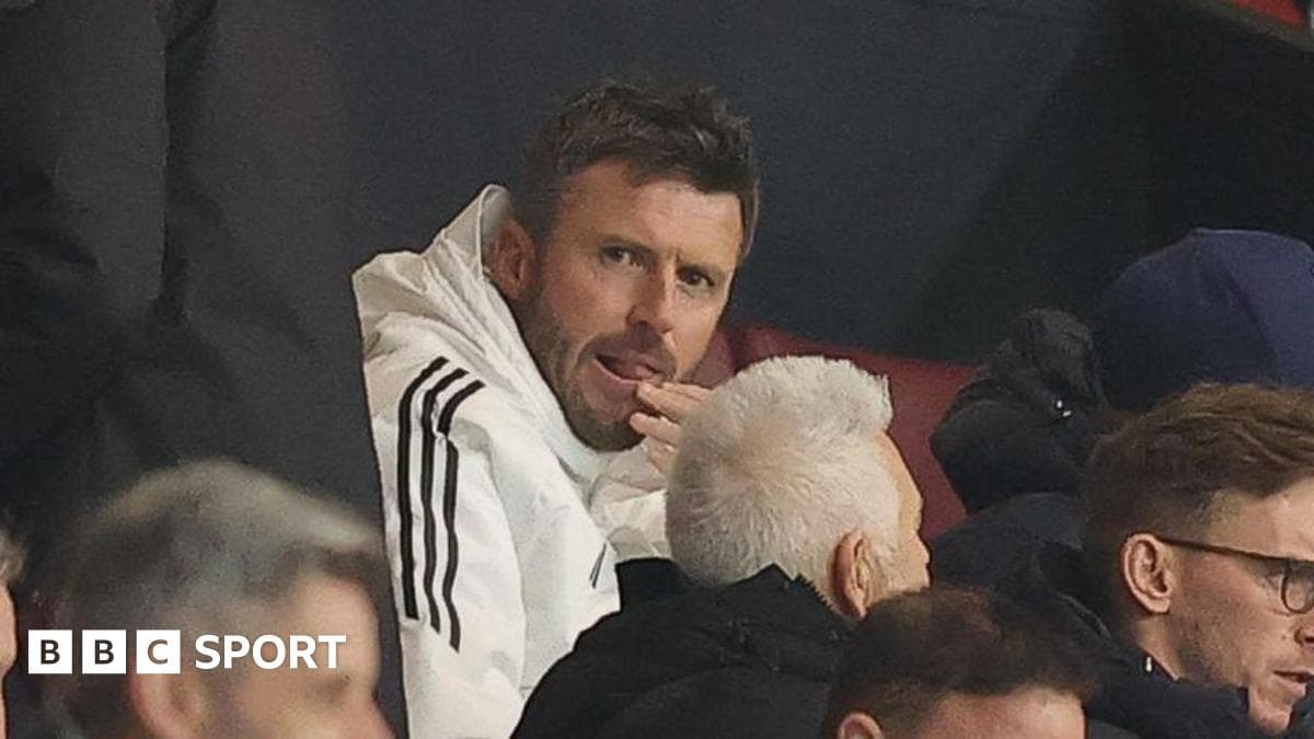 Man in white jacket watching from the stands Man in white jacket watching from the stands