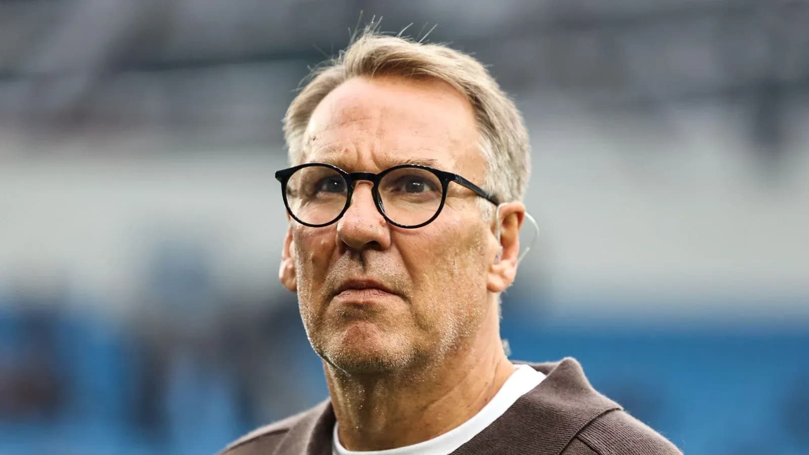 Man with glasses on field during a match Man with glasses on field during a match