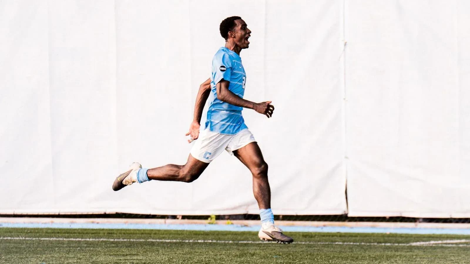 Player celebrating while running on the field Player celebrating while running on the field