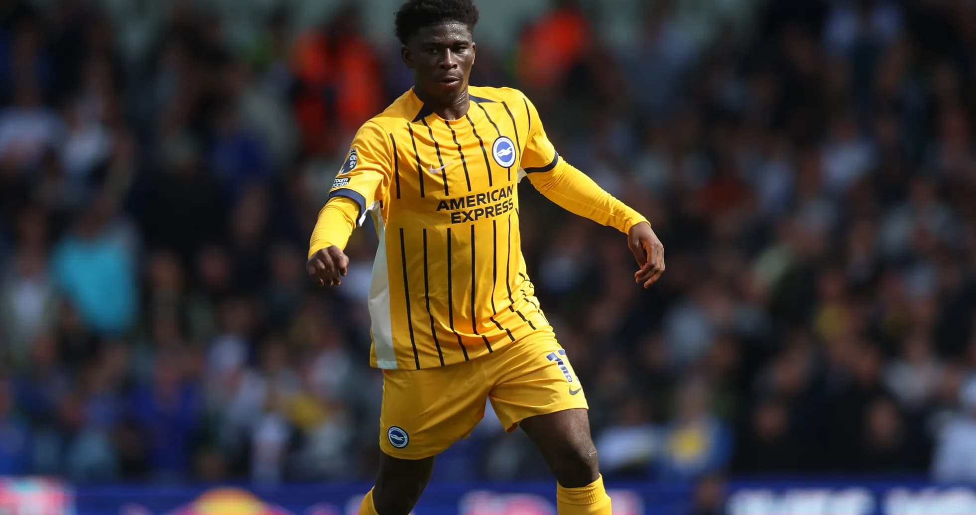 Player in yellow jersey running on the pitch Player in yellow jersey running on the pitch