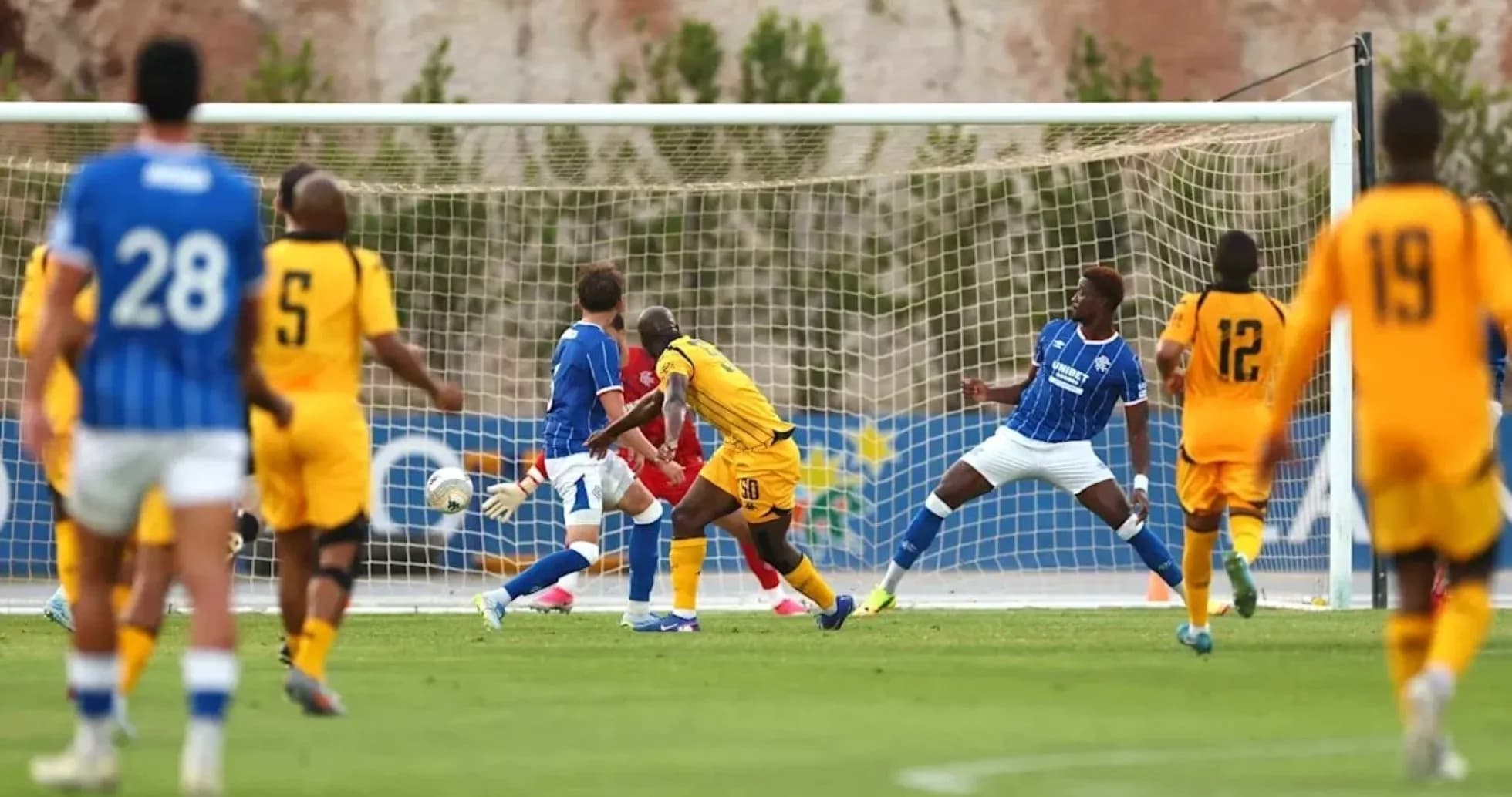 Player shooting at goal during soccer match Player shooting at goal during soccer match