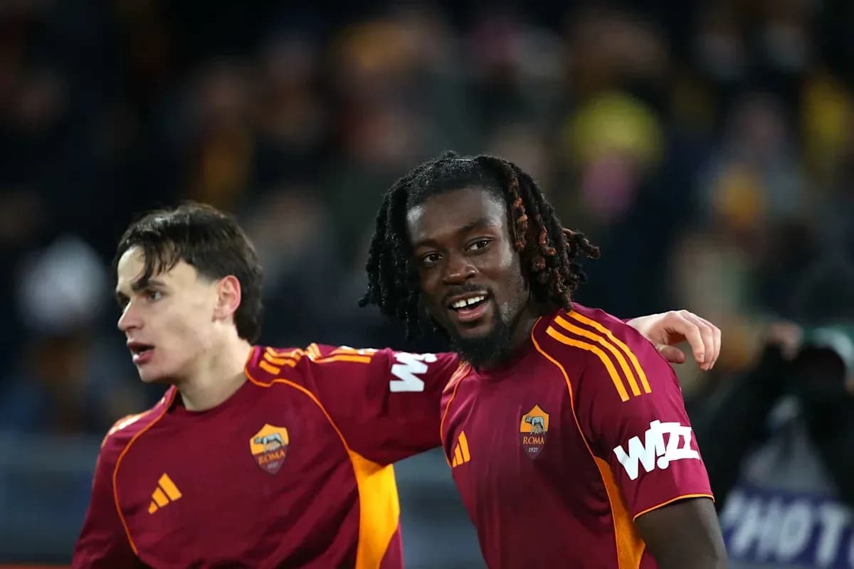 Two AS Roma players celebrating on the field Two AS Roma players celebrating on the field