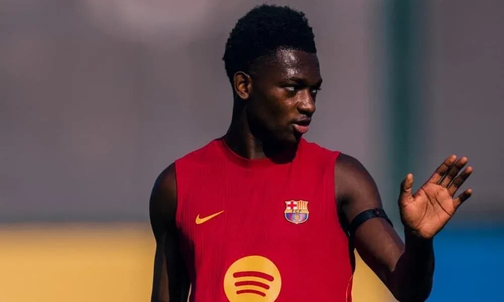 Player in red training kit gesturing during practice Player in red training kit gesturing during practice