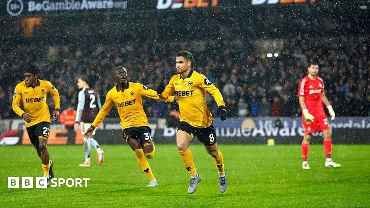 Player celebrating goal in rainy football match Player celebrating goal in rainy football match