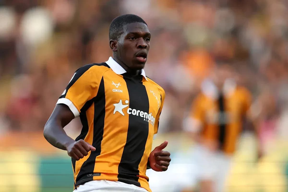 Player in black and orange jersey running on field Player in black and orange jersey running on field