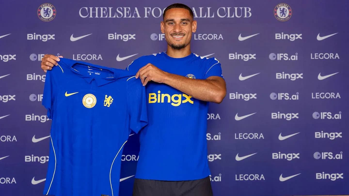 Player holding Chelsea FC jersey at press conference Player holding Chelsea FC jersey at press conference