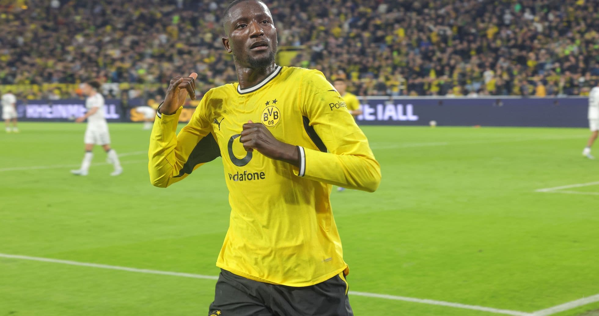 Borussia Dortmund player celebrating on the pitch Borussia Dortmund player celebrating on the pitch