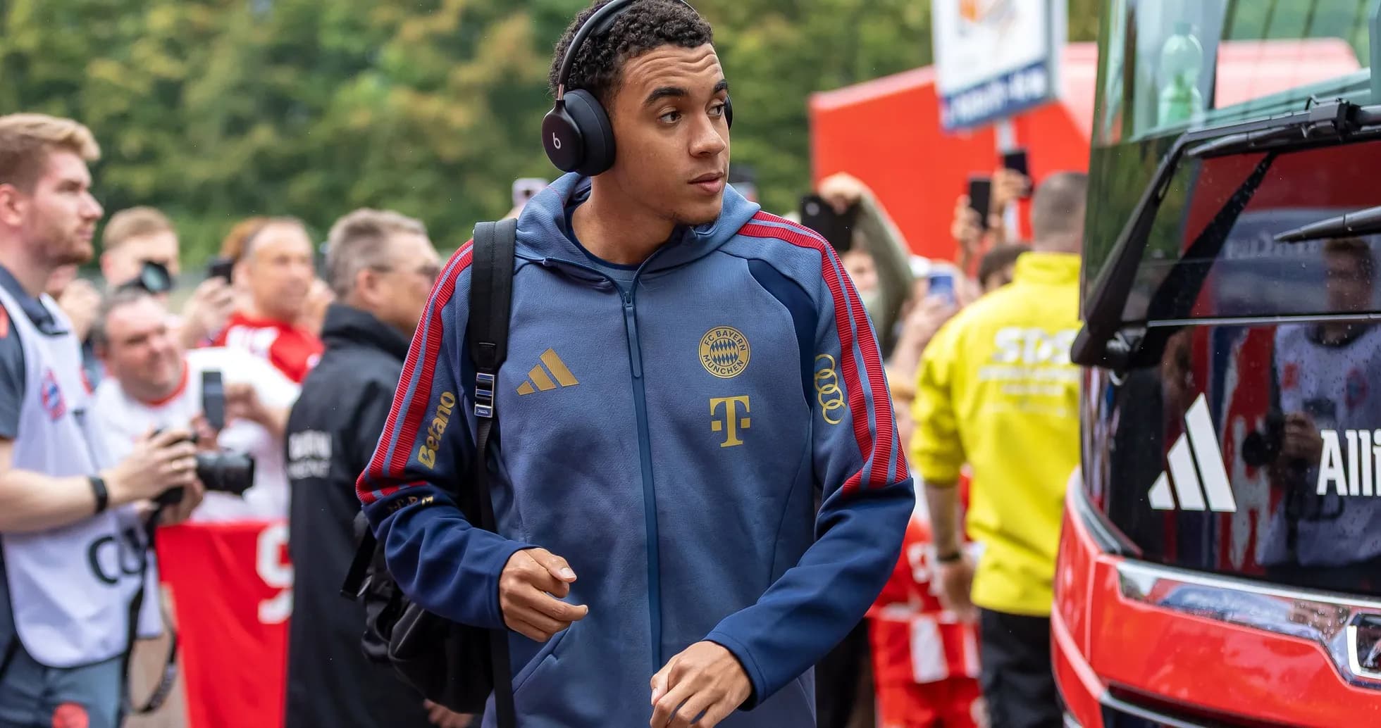 Player arriving at stadium wearing headphones Player arriving at stadium wearing headphones