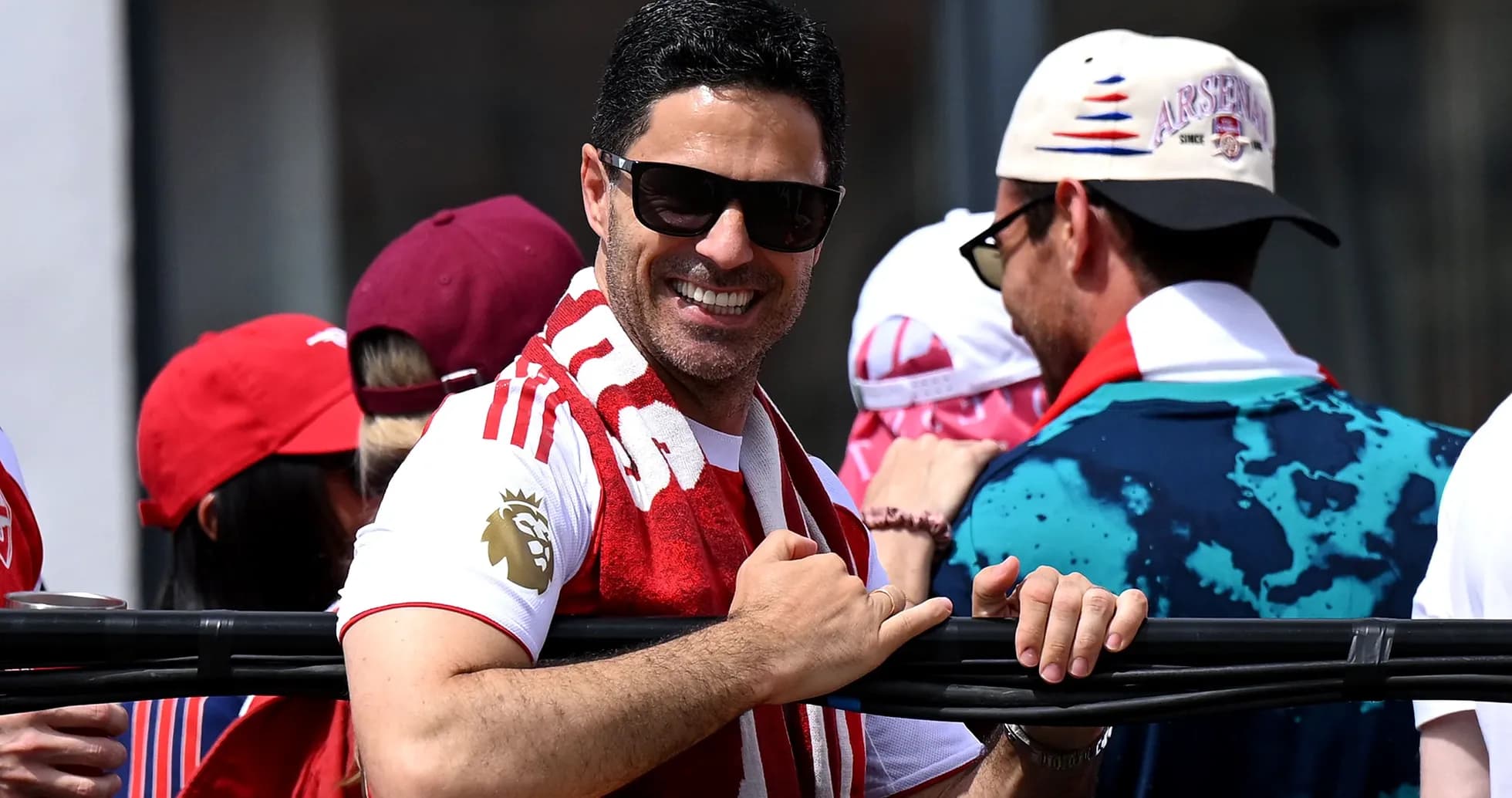 Man in sunglasses smiling with Arsenal scarf Man in sunglasses smiling with Arsenal scarf
