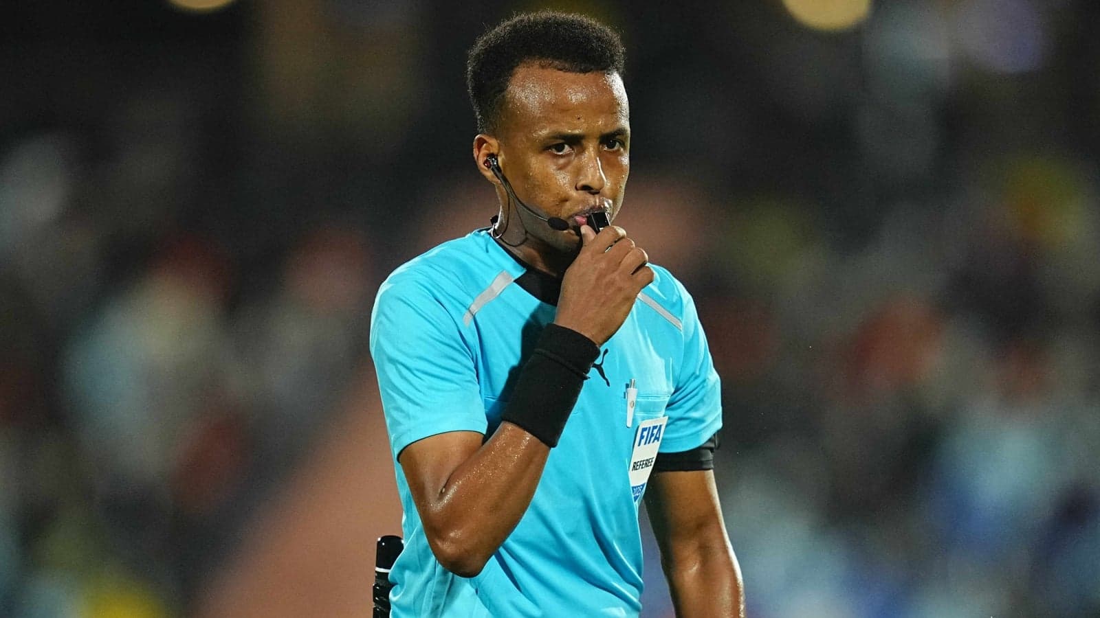 Referee blowing whistle during a football match Referee blowing whistle during a football match