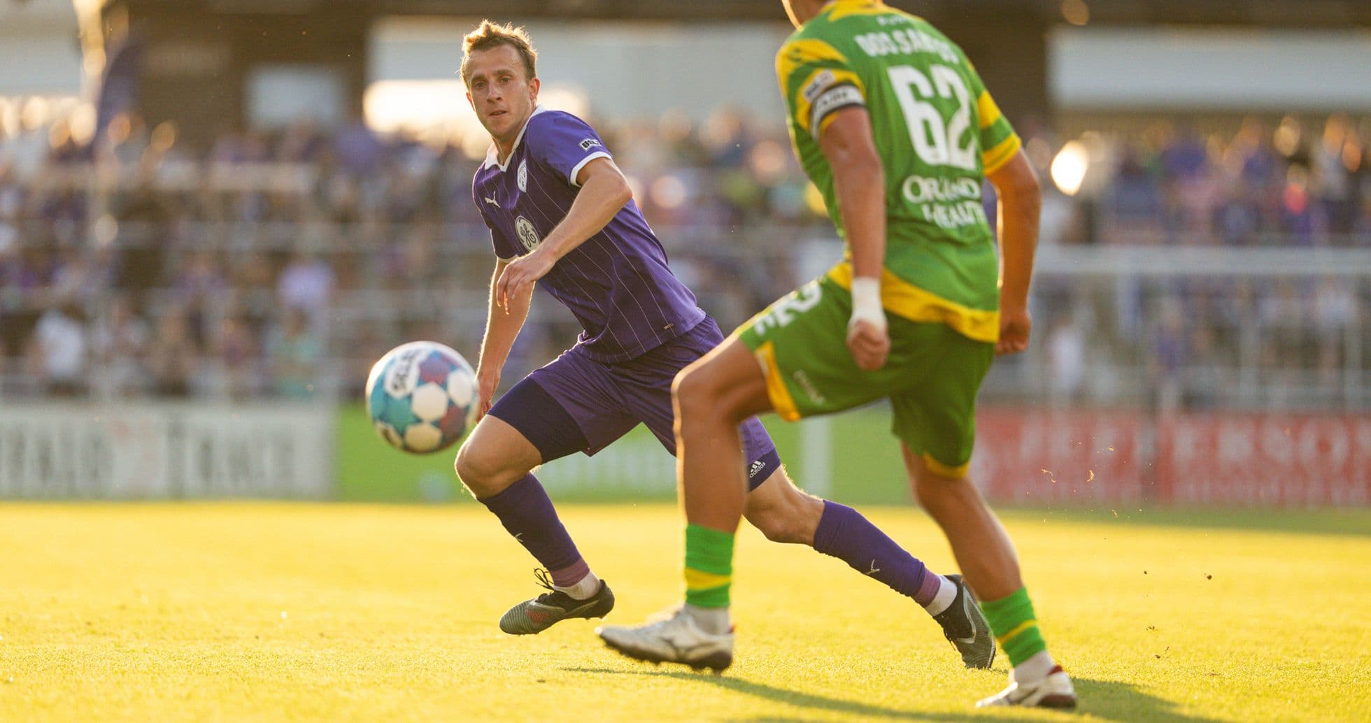 Player passing the ball during Louisville City match Player passing the ball during Louisville City match