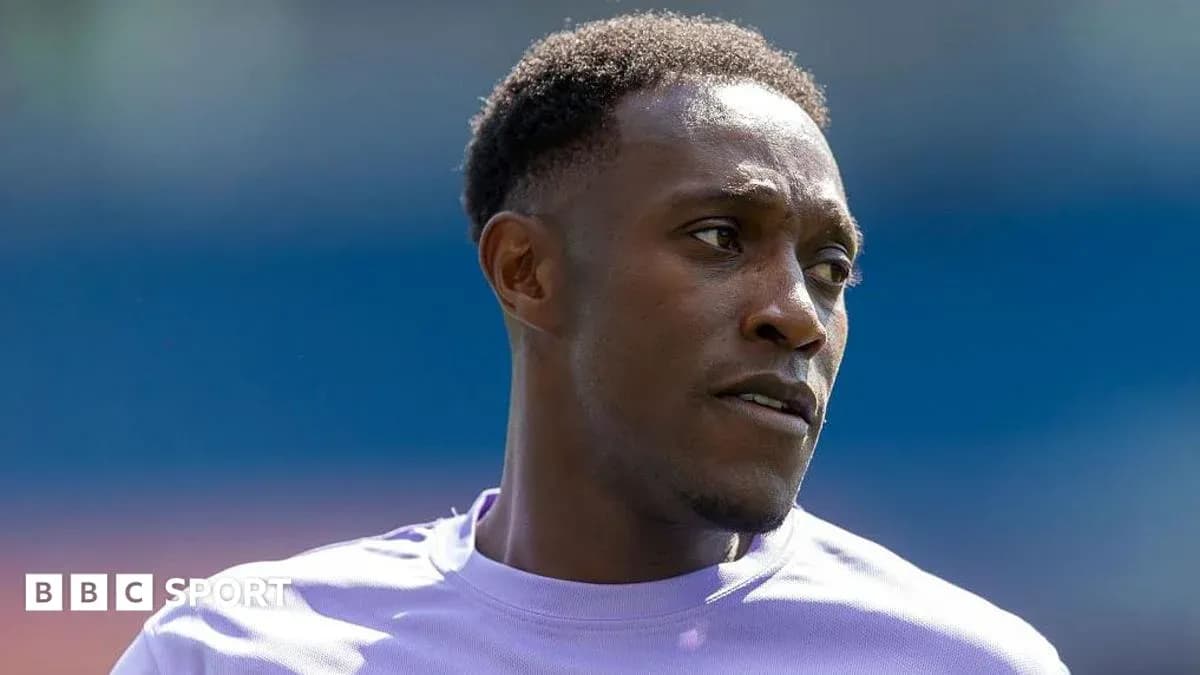 Football player in purple kit during warm-up Football player in purple kit during warm-up