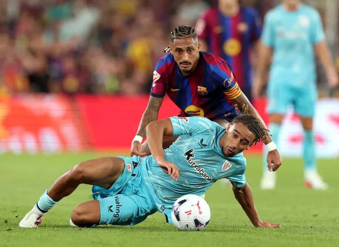 Barcelona player challenging Athletic Club player for ball Barcelona player challenging Athletic Club player for ball