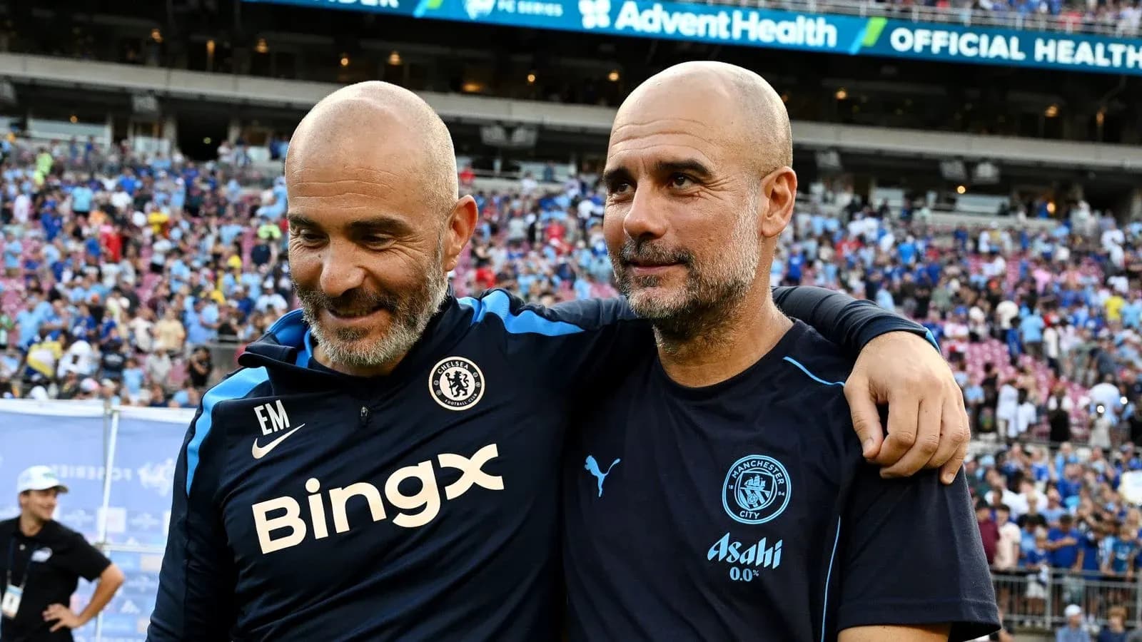 Two football coaches embracing after a match Two football coaches embracing after a match