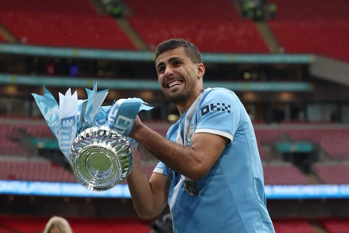 Player celebrating with trophy at Wembley Stadium Player celebrating with trophy at Wembley Stadium