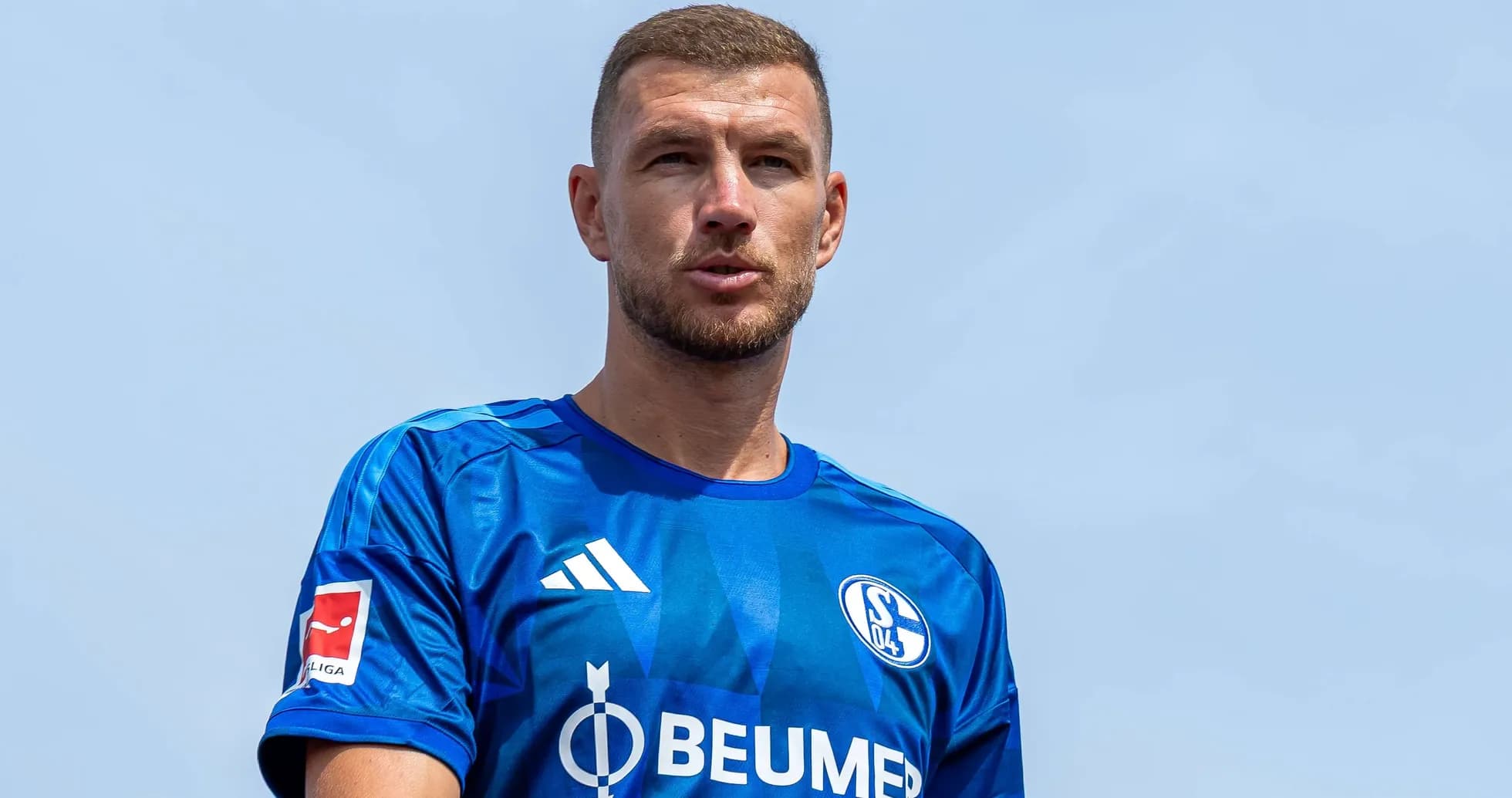 Player wearing blue Schalke 04 jersey outdoors Player wearing blue Schalke 04 jersey outdoors