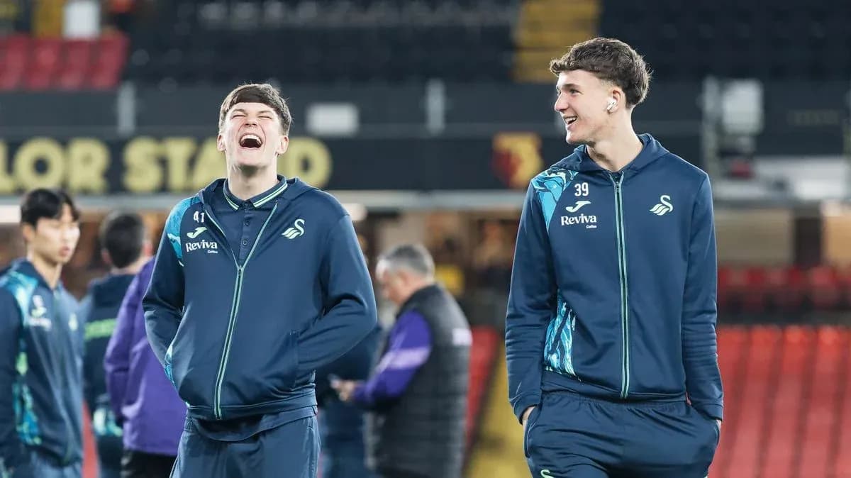 Two Swansea City players smiling during warm-up Two Swansea City players smiling during warm-up