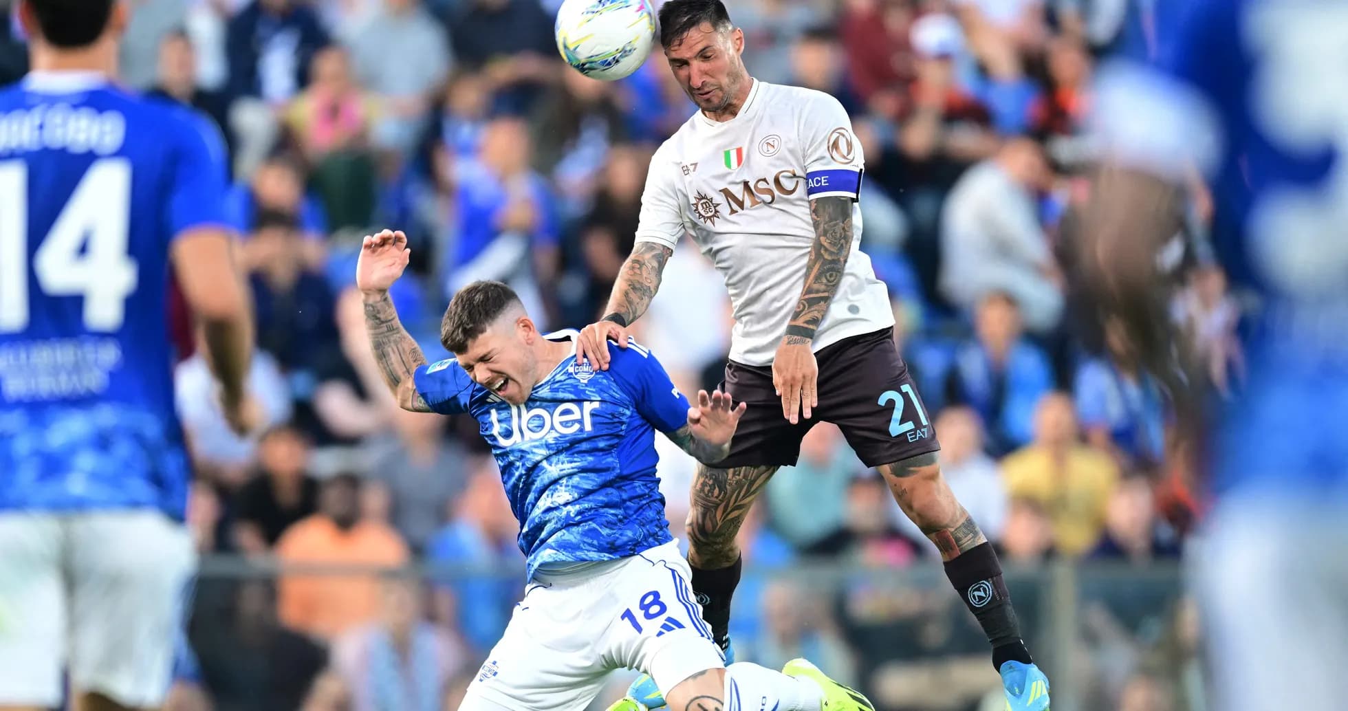 Napoli player challenging Como player during match Napoli player challenging Como player during match