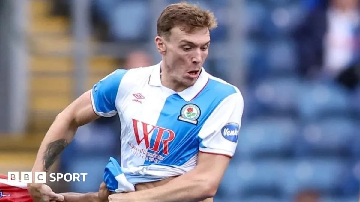 Player pulling at shirt during football match Player pulling at shirt during football match