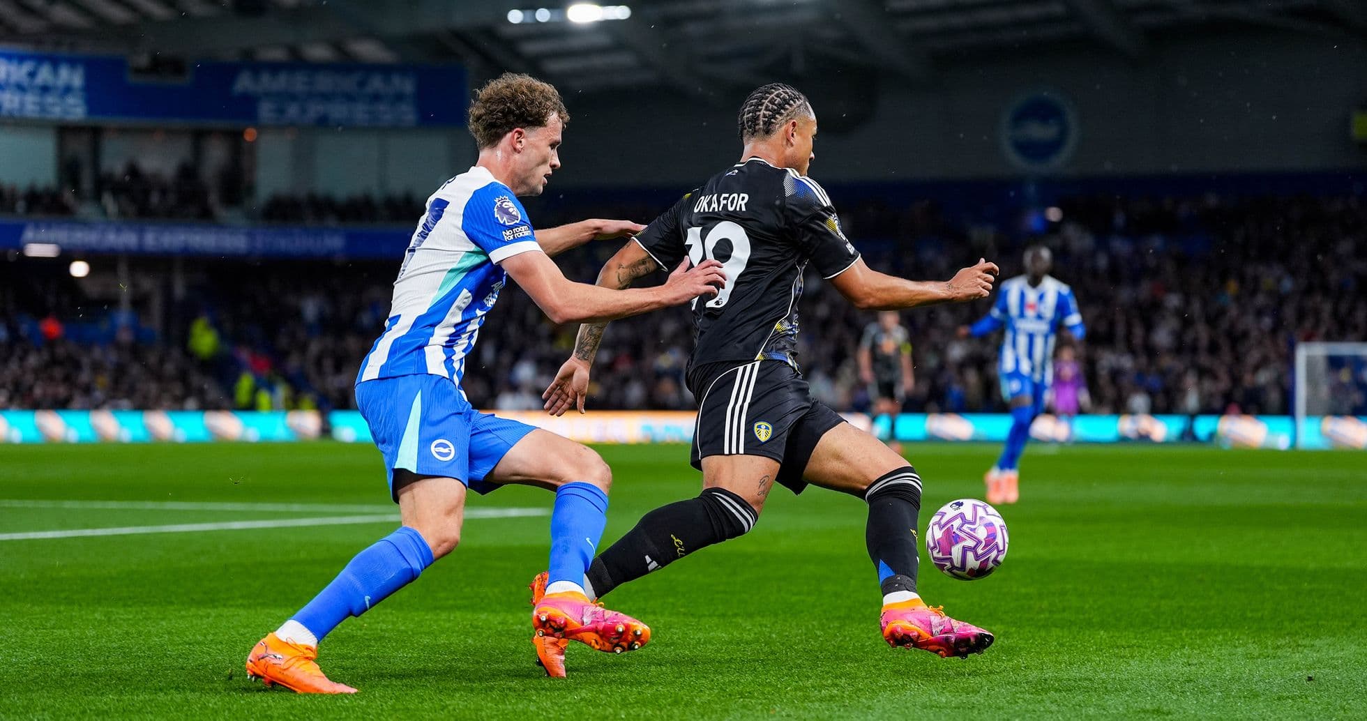 Player from Leeds avoiding tackle by Brighton player Player from Leeds avoiding tackle by Brighton player