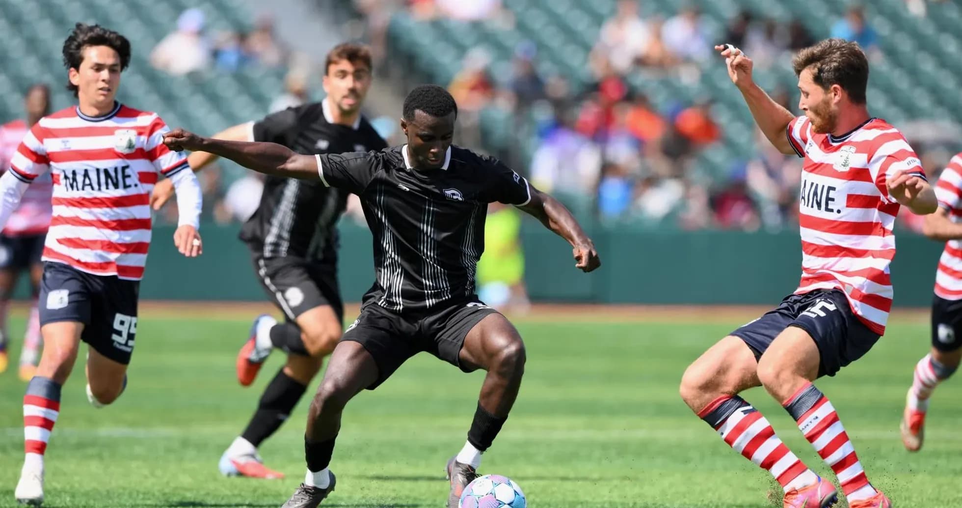 Players competing for the ball in USL match Players competing for the ball in USL match