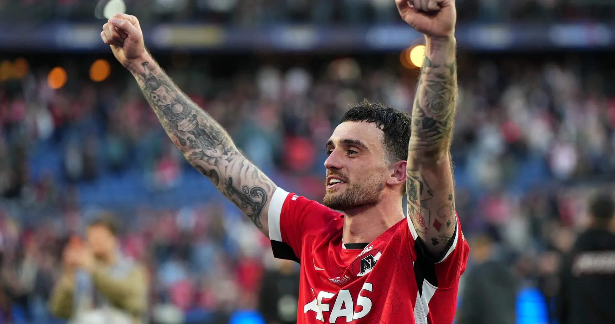 Player celebrating victory with raised arms Player celebrating victory with raised arms