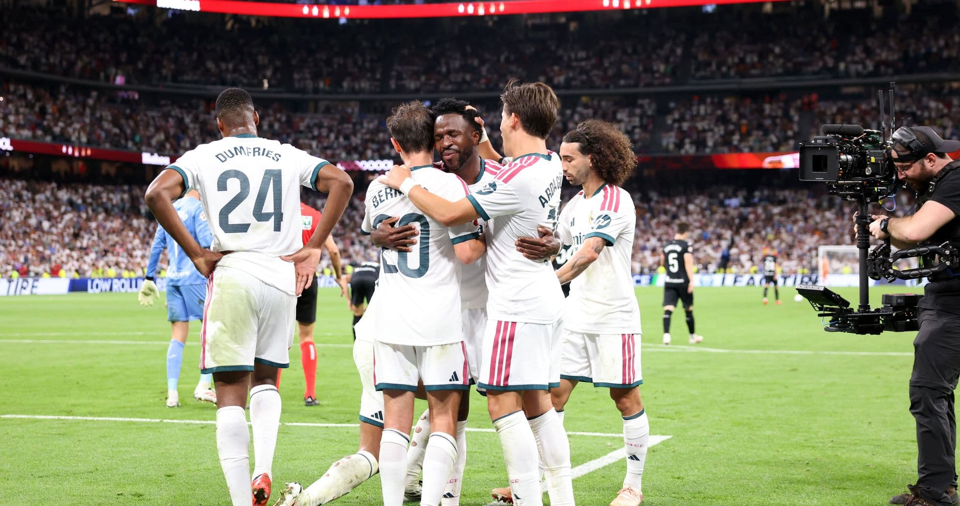 Players celebrating a goal on the field Players celebrating a goal on the field