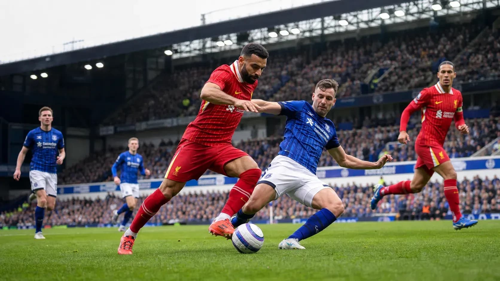 Players contesting the ball during Liverpool vs Everton match Players contesting the ball during Liverpool vs Everton match
