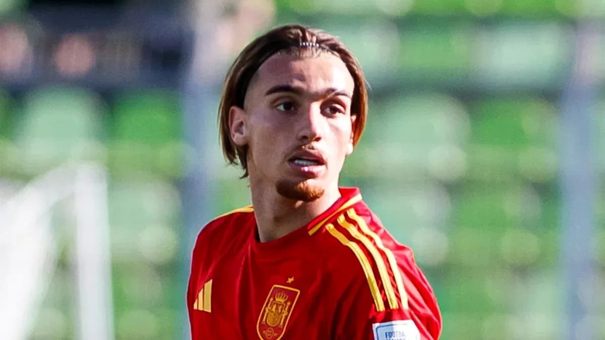 Player in red Spain jersey on football field Player in red Spain jersey on football field