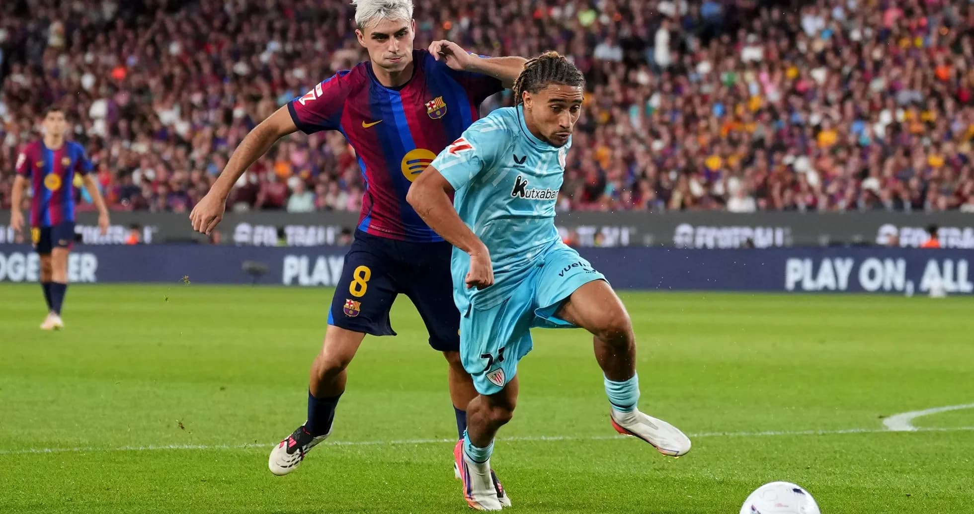 Barcelona player challenging opponent for the ball Barcelona player challenging opponent for the ball