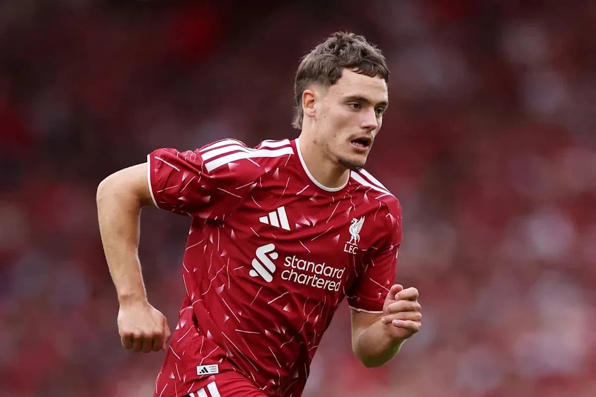 Player running on the pitch wearing Liverpool kit Player running on the pitch wearing Liverpool kit