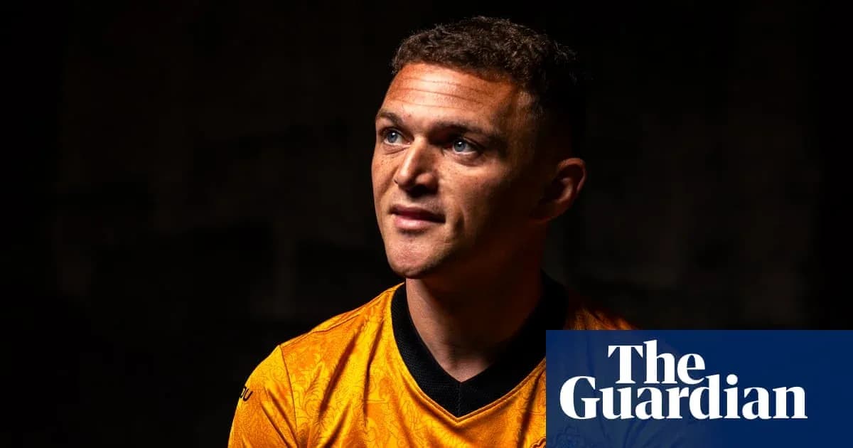 Player in orange jersey looking off-camera Player in orange jersey looking off-camera