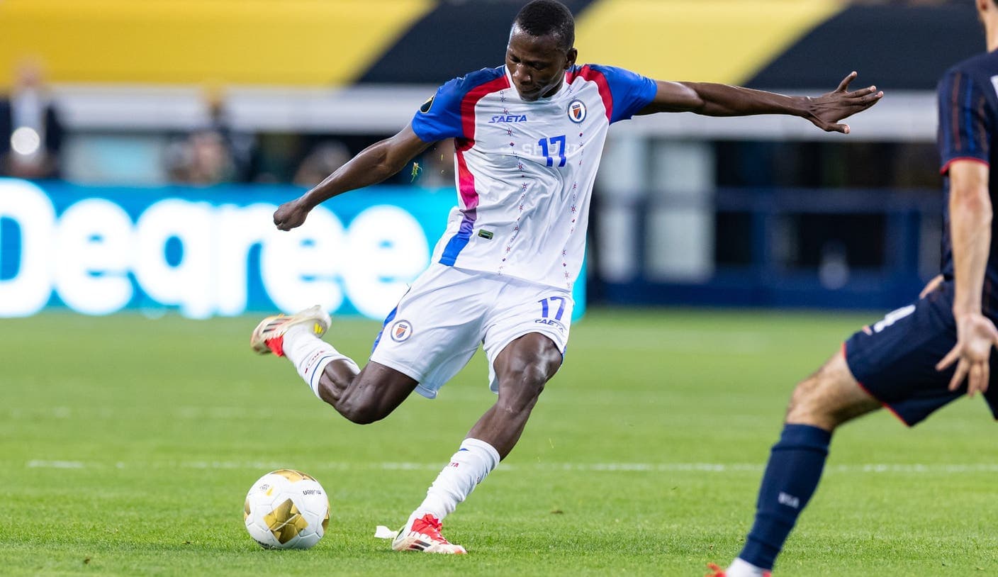 Haitian player kicking the ball during match Haitian player kicking the ball during match