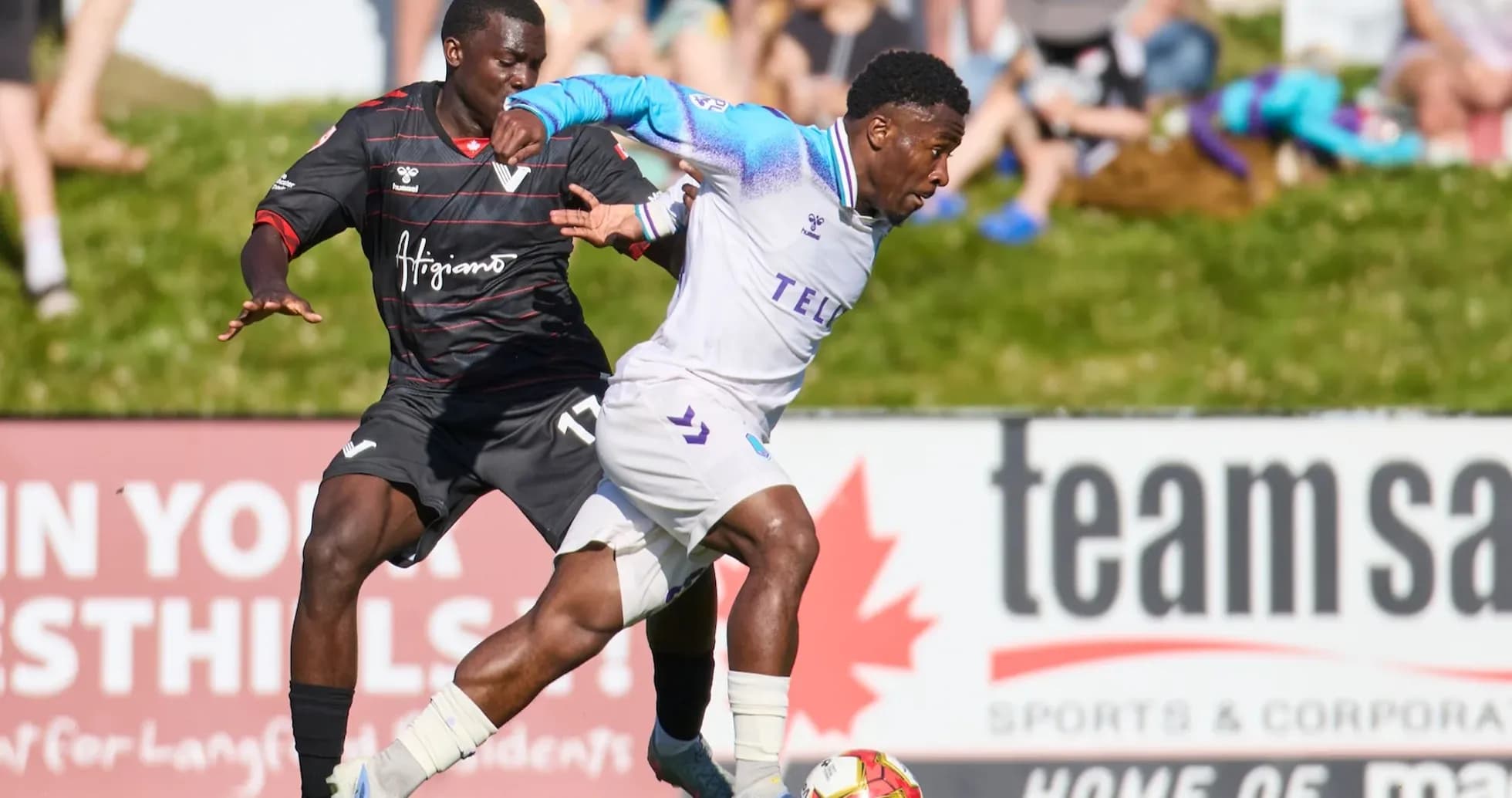Pacific FC player dribbling past Vancouver FC opponent Pacific FC player dribbling past Vancouver FC opponent