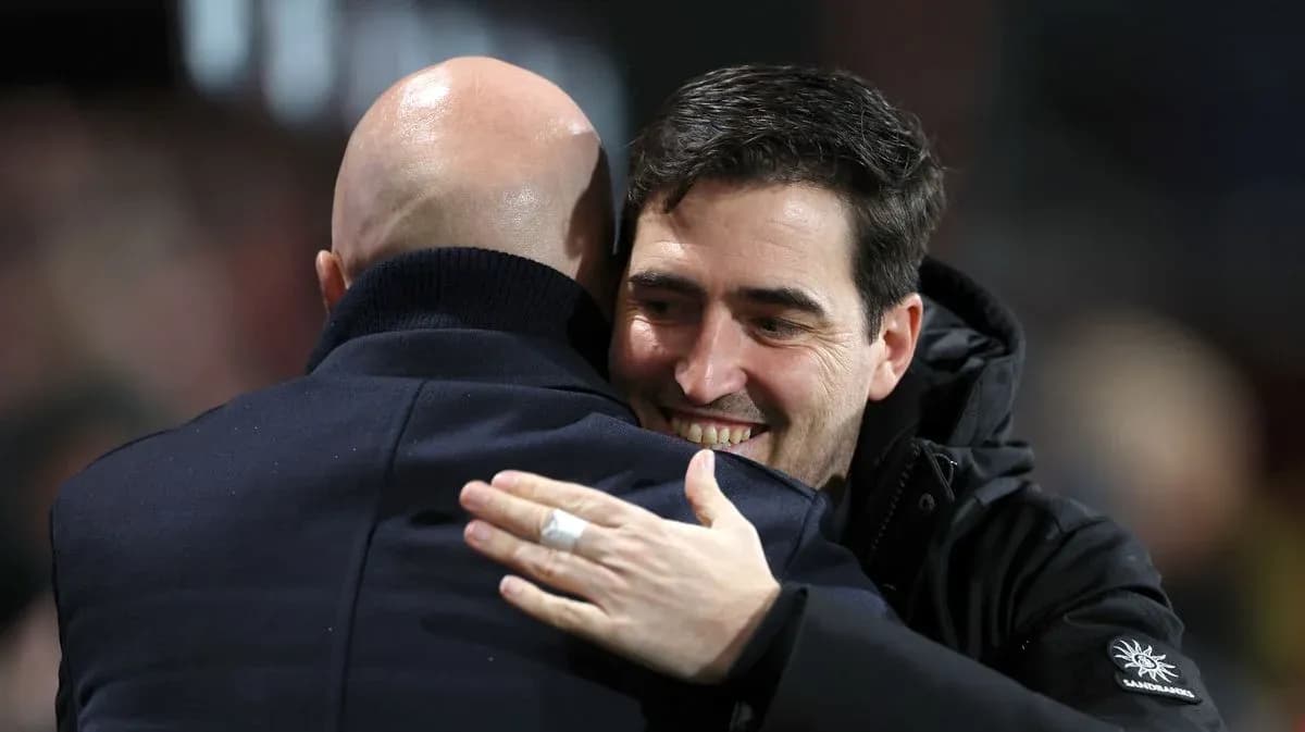Two coaches embracing on the sidelines Two coaches embracing on the sidelines