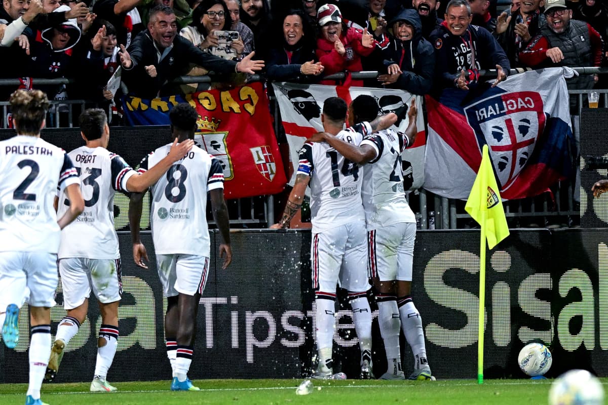 Cagliari players celebrating a goal with fans Cagliari players celebrating a goal with fans
