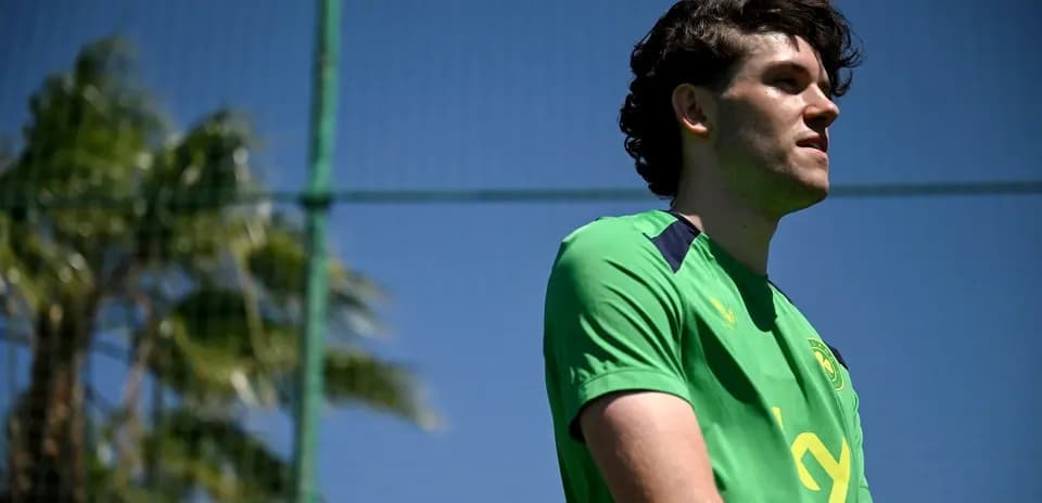 Player in green jersey at training facility Player in green jersey at training facility