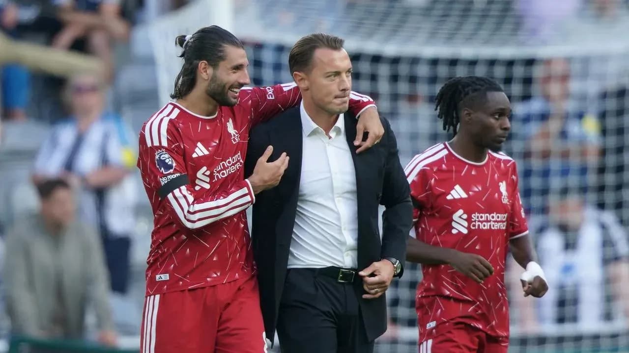 Liverpool players interacting with coach on sideline Liverpool players interacting with coach on sideline