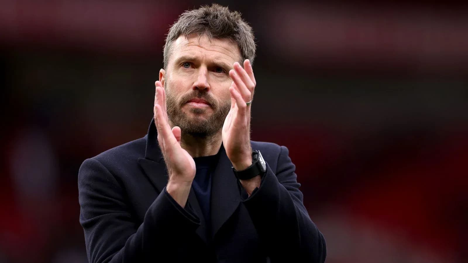 Coach applauding fans during match at stadium Coach applauding fans during match at stadium