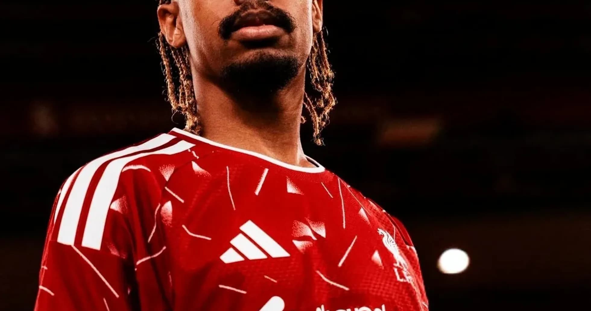 Player wearing red Liverpool jersey posing confidently Player wearing red Liverpool jersey posing confidently