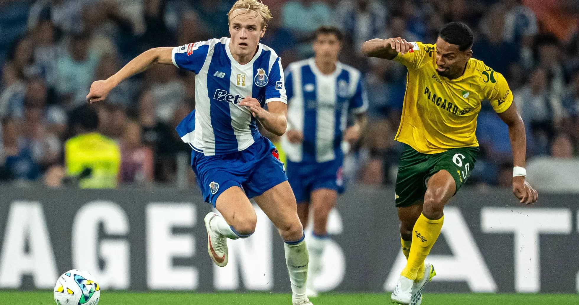 Player from FC Porto sprinting with ball during match Player from FC Porto sprinting with ball during match