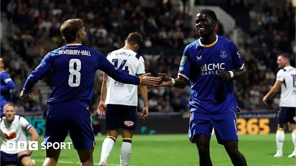 Two players celebrating a goal on the pitch Two players celebrating a goal on the pitch