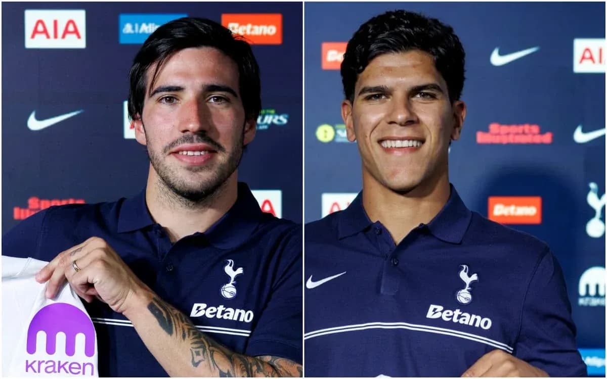 Two players holding jerseys at press conference Two players holding jerseys at press conference