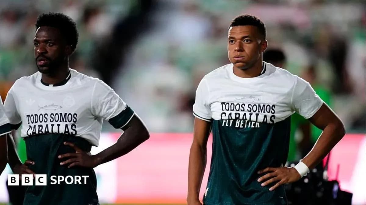 Two players wearing matching shirts on the pitch Two players wearing matching shirts on the pitch